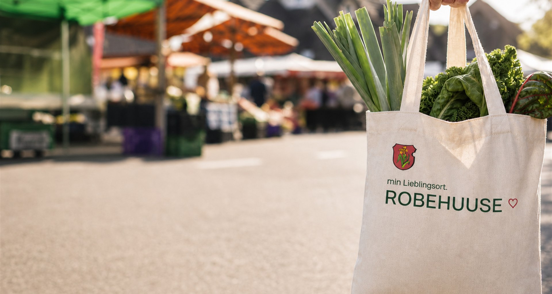 Stoffbeutel mit Robehuuse-Logo am Wochenmarkt